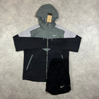  Nike Windrunner Black Grey Shorts Set – black, grey and white colour-block hooded jacket with matching black Nike shorts laid flat with tag attached