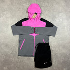 Nike Windrunner Playful Pink Shorts Set – pink, black and grey colour-block hooded jacket with black Nike shorts laid flat with tag attached
